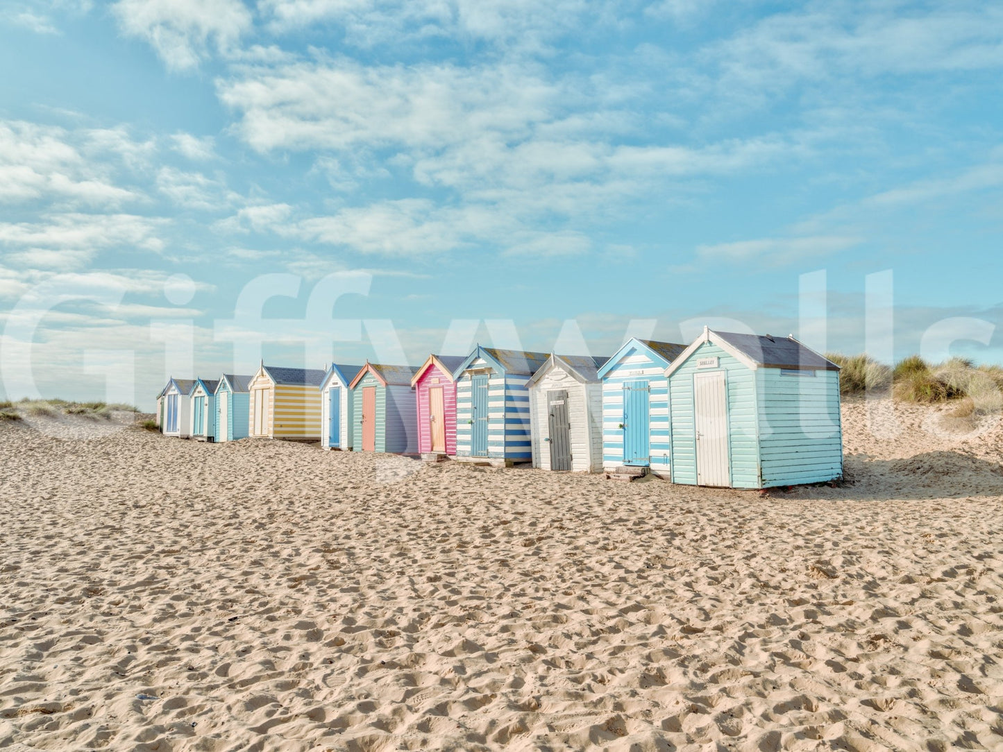 Soft blue sky above colorful huts in Beach Huts on the Shore Wall Mural scene, GD8871