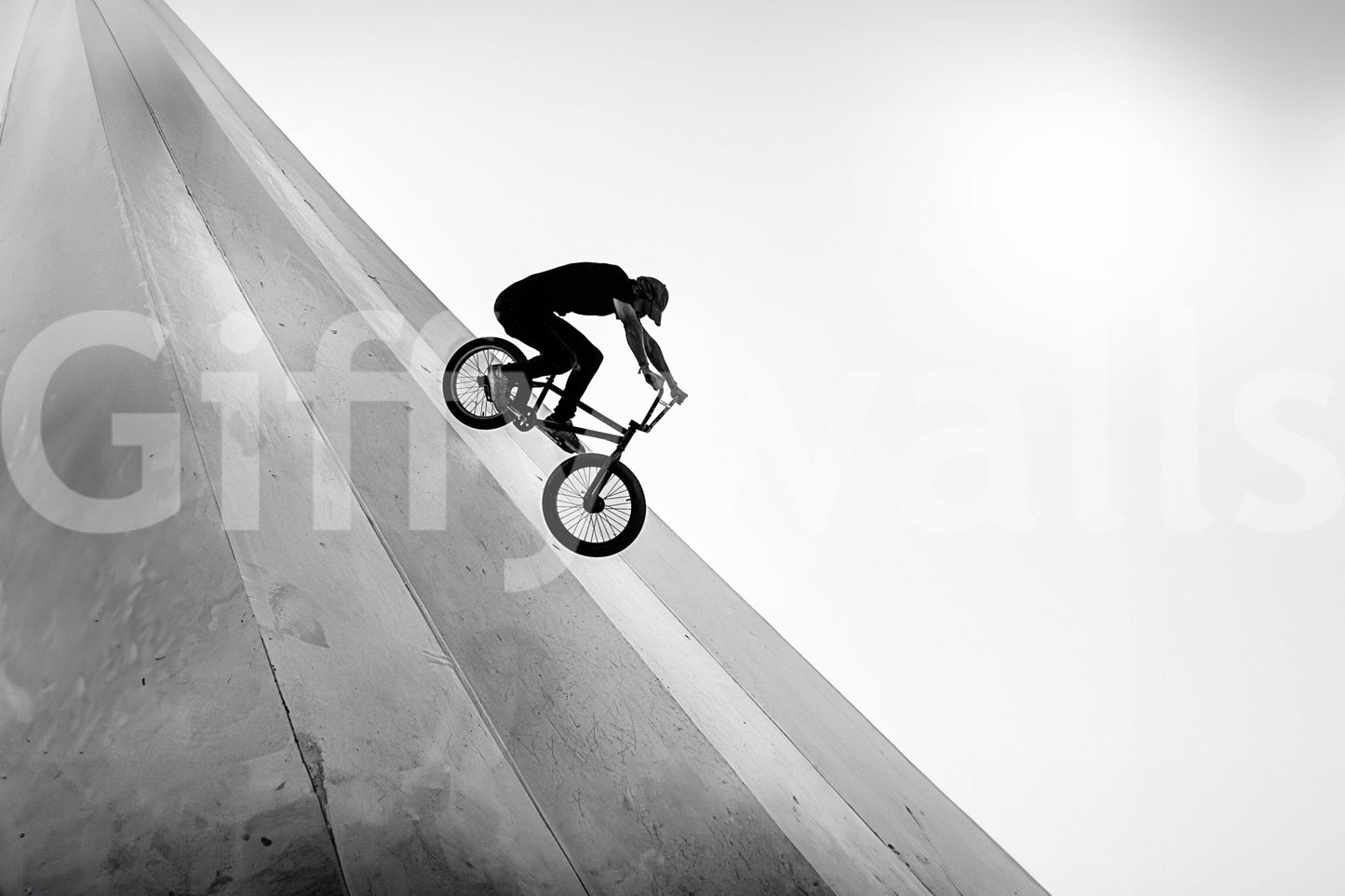 BMX rider on steep concrete wall