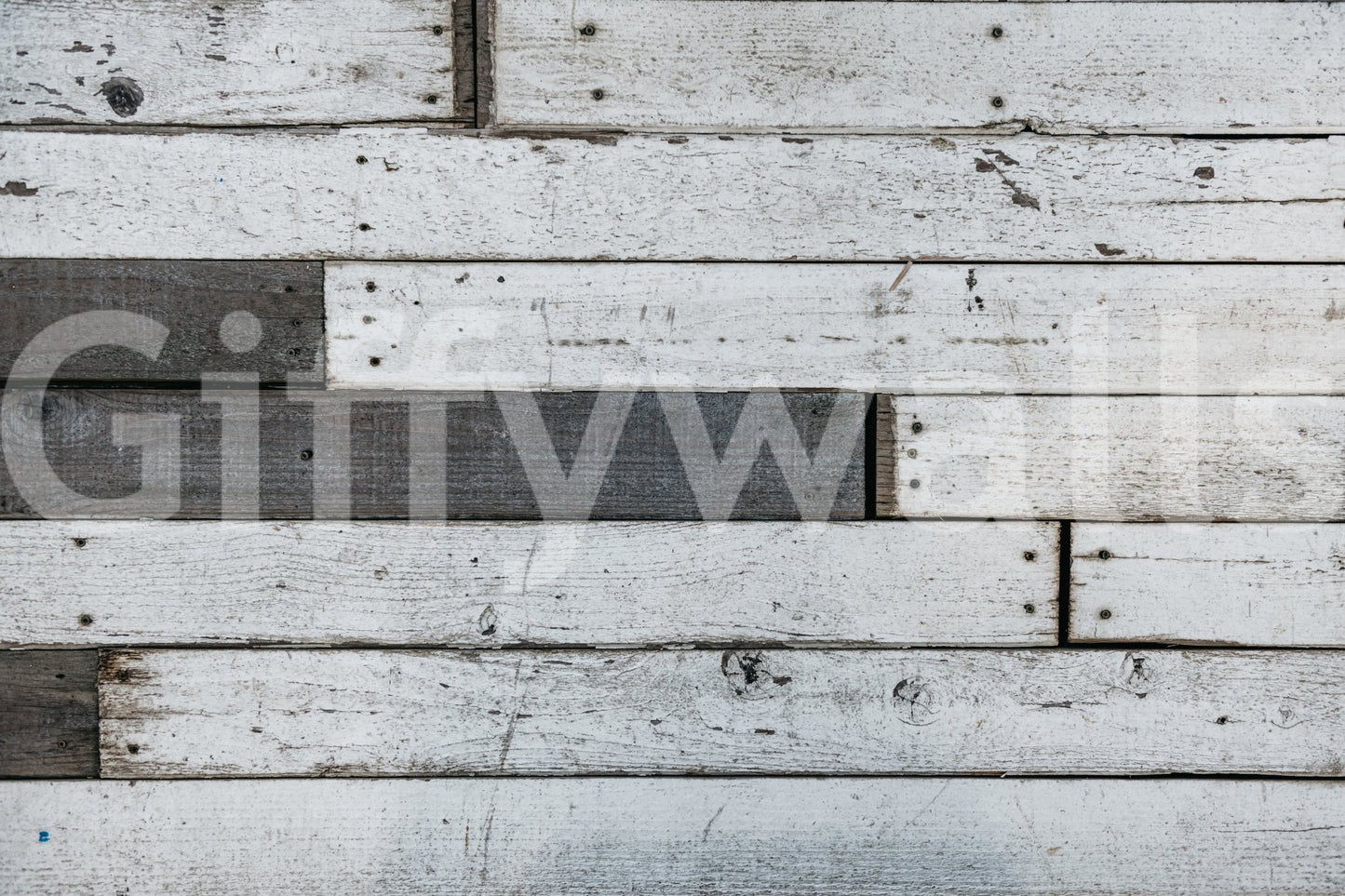 Applying the simple, removable peel and stick wood panel wallpaper.