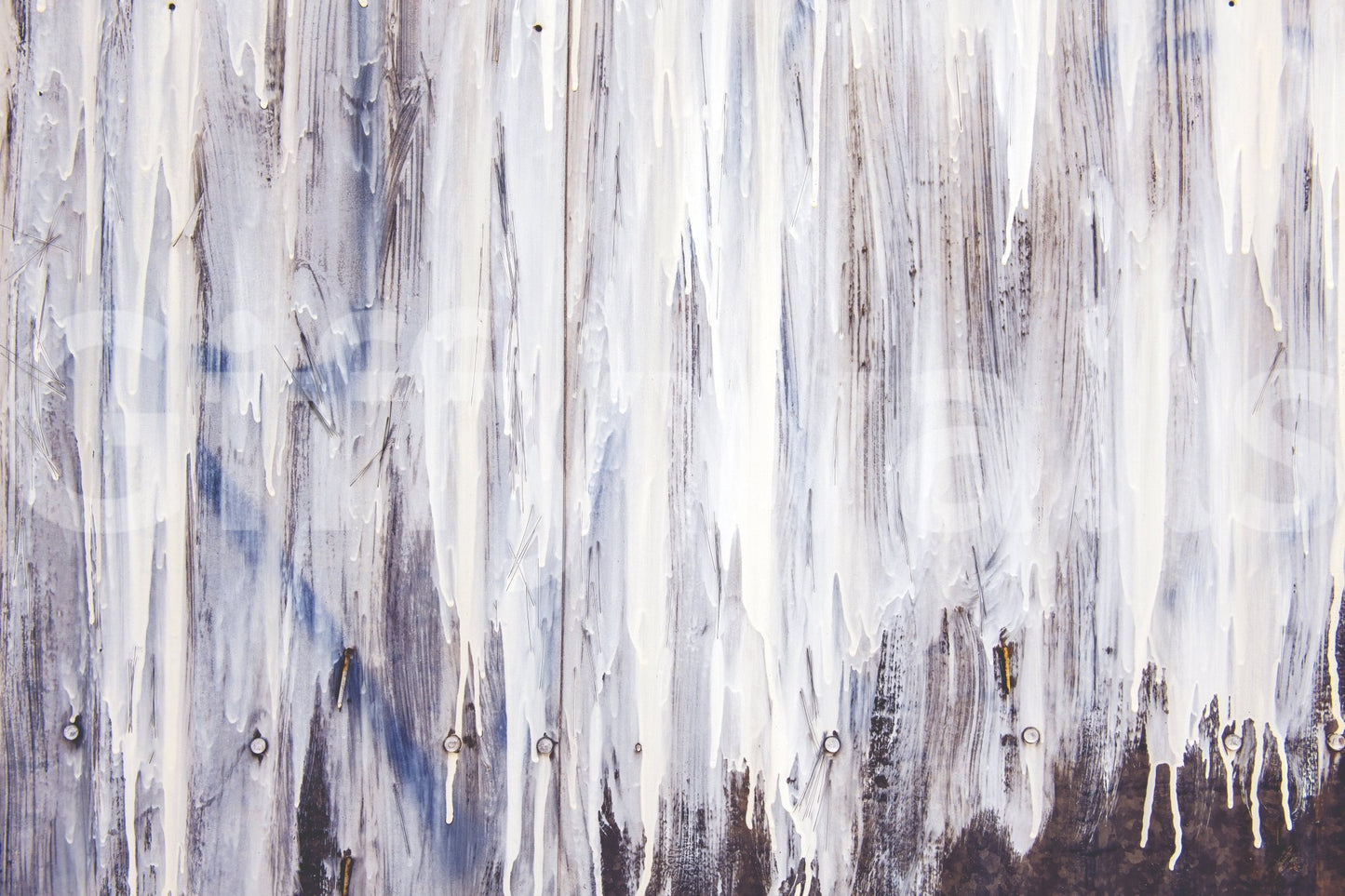 Abstract beauty of the Dripping Serenity peel and stick mural behind a lounge chair.