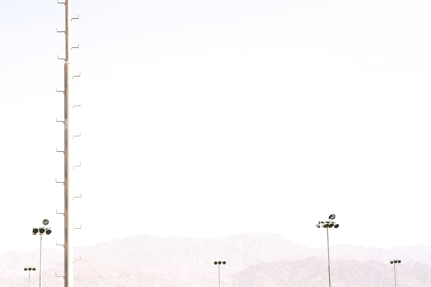 Milky sky frames the tall floodlight stands in this Eilat #32 wall mural GD4802