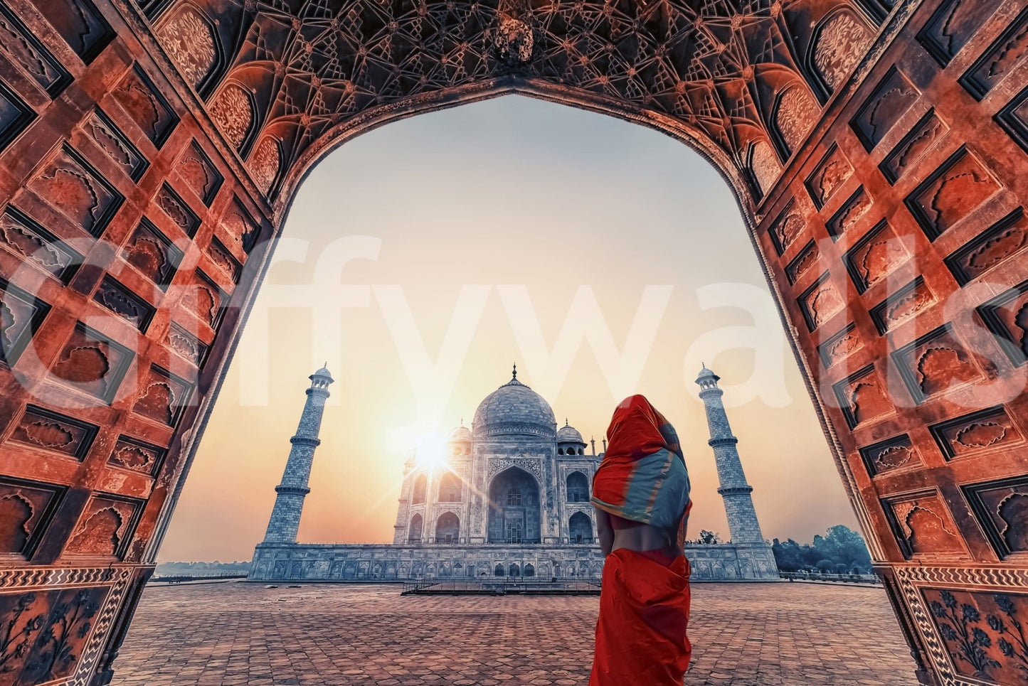 Through a red stone gateway, the sunset Taj wall mural shows domes and tall minarets