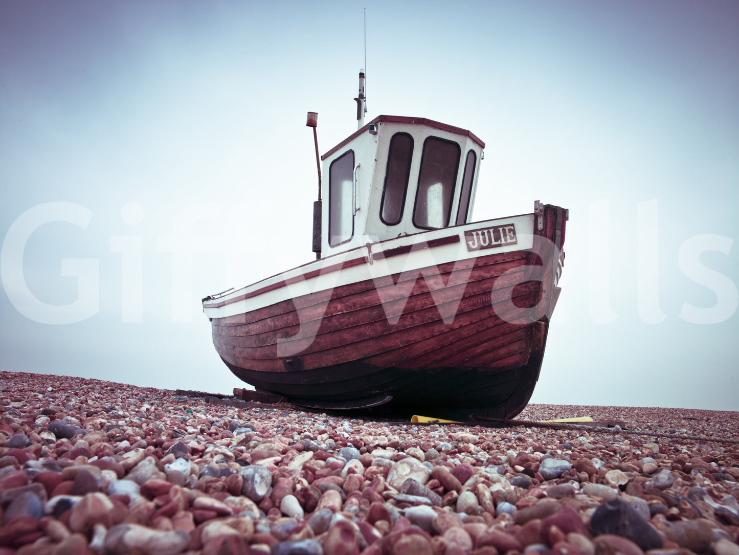 Boat Resting on Pebbled Strand Wall Mural