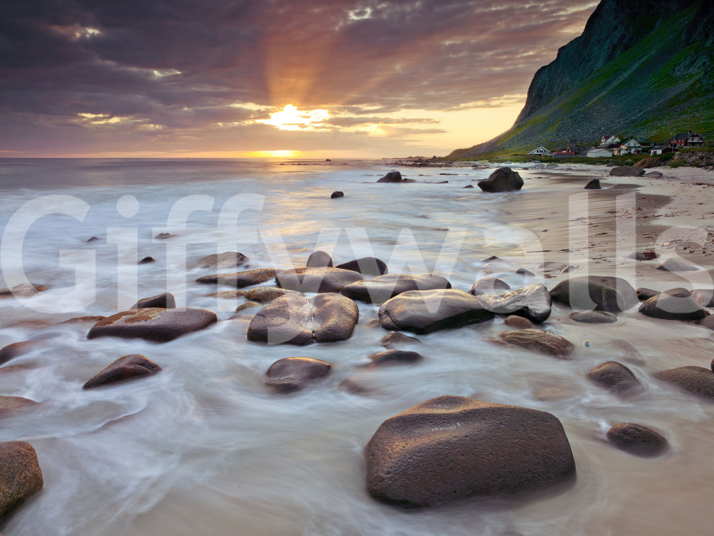 A small village edges this coastal sunset serenity wall mural scene.