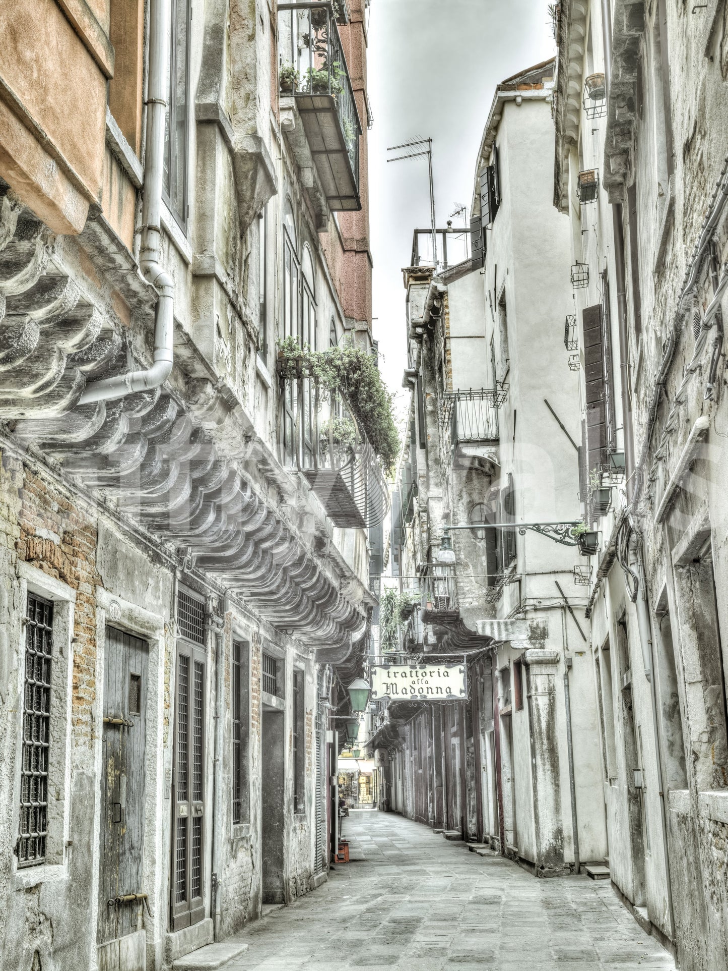 Historic urban street wall mural with drain pipes and Venetian details.