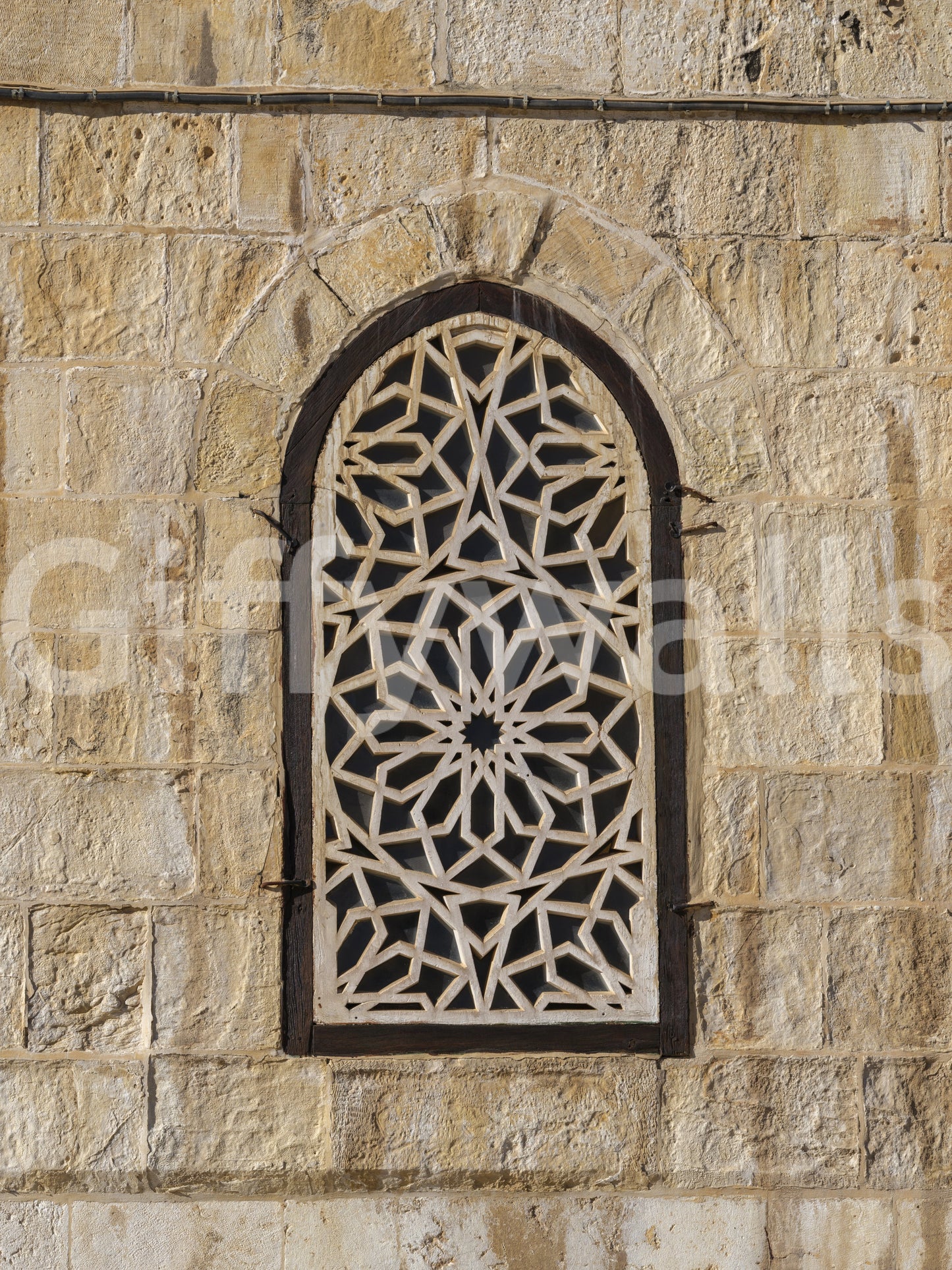 Beige sandstone texture with geometric lattice detail in Moorish wall mural., GD10440
