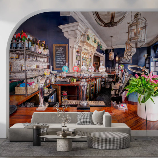 Home bar mural in a living room with a grey sofa under an arch GD12176