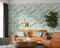 Warm sitting area with blue chinoiserie wallpaper and woodland animal detail