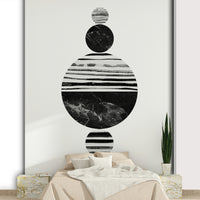 Artistic composition of striped and solid textured spheres in a vertical alignment.

