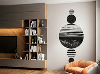 Abstract geometric design featuring stacked textured black and white circles.

