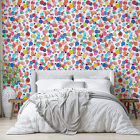 Soft watercolor polka dot wallpaper with bright hues

