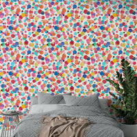 Multicolor polka dots in watercolor style on wall

