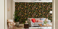 Lush green leaves and vibrant tropical flowers on wallpaper.

