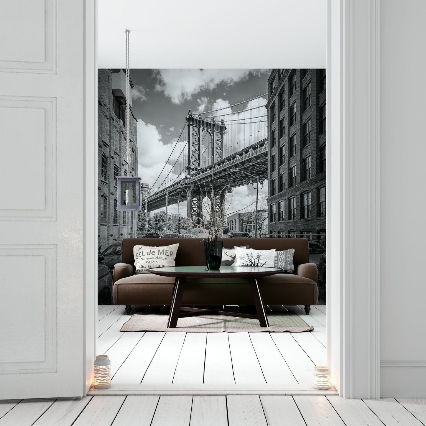 Black-and-white mural of Manhattan Bridge with urban skyline.

