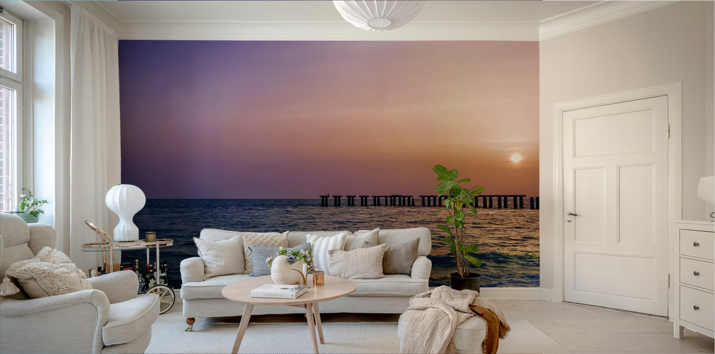 Seaside mural showing vibrant sunset colors and sandy shore.

