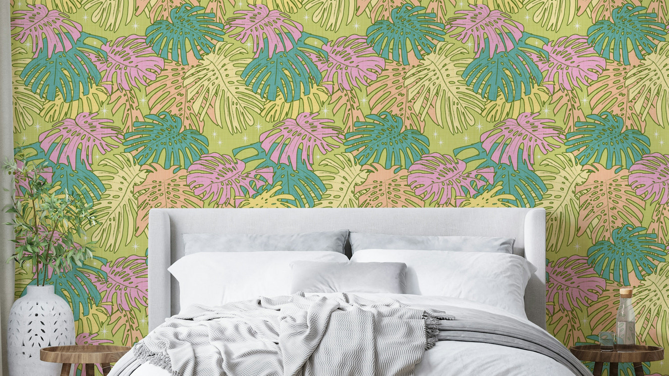Monstera leaves in pastel colors on avocado wall covering

