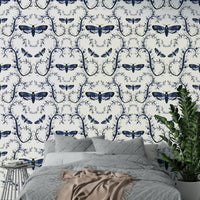 Moody gothic wallpaper showing moths over dark botanical swirls.


