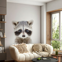 Nursery mural with baby raccoon and leafy background

