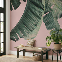 Banana leaf mural with blush background accents

