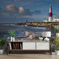 Seaside mural featuring Portland Bill Lighthouse at sunset.

