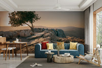 Tranquil wall mural with a lone tree silhouette at dusk.

