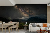 The Milky Way stretching over a green valley wall mural

