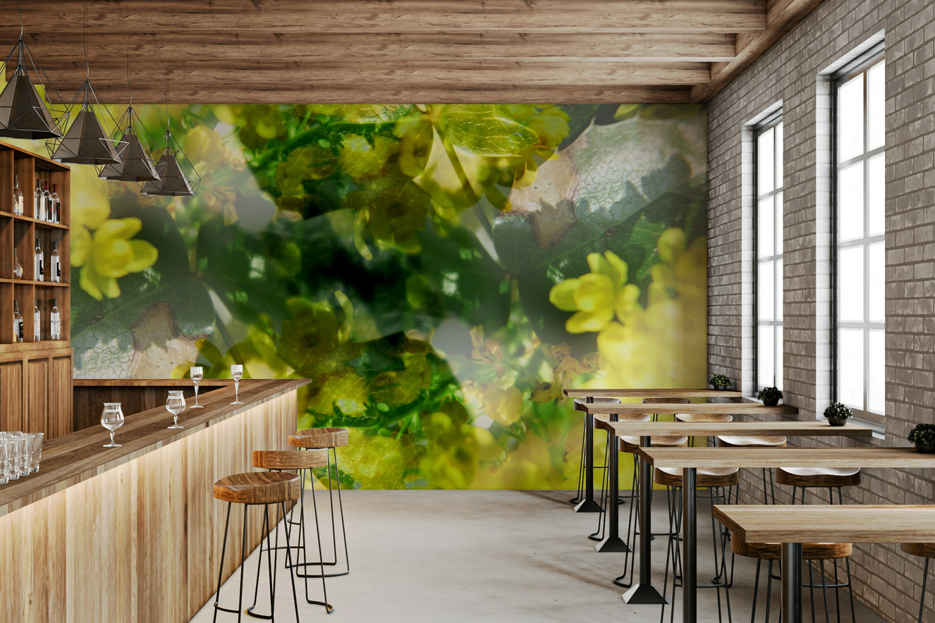 An abstract wall mural showing a floral design with vibrant green and yellow colors.

