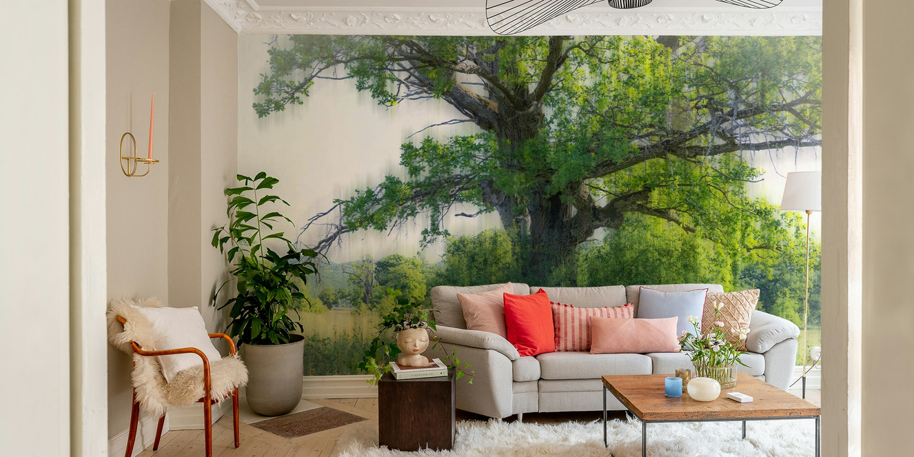 A photo-realistic wall mural of a majestic green tree in a landscape.

