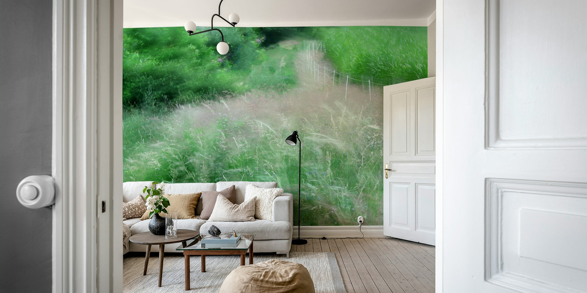 An abstract wall mural of a blurry, lush green pathway.