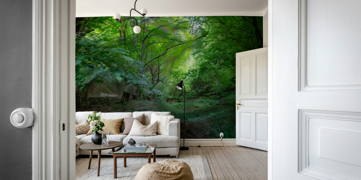 A wall mural of a lush green forest with a pathway.

