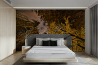 A close-up view of the golden leaves against the twilight sky.

