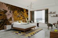 The image shows golden and orange leaves on tree branches.

