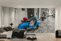 A wall mural of a vintage blue scooter.

