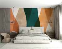 A minimalist chair is placed in front of the mural.

