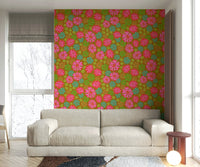 The mural is installed in a cheerful living room behind a simple, light-colored sofa.

