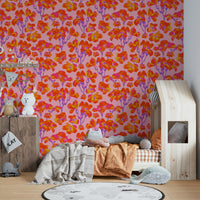 The image shows a full wall with a pattern of wild roses and leaves.

