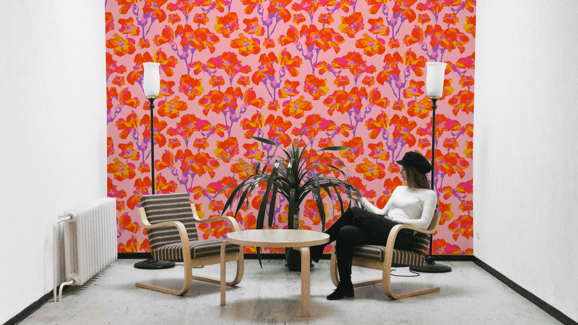The mural is installed in a cheerful living room behind a simple, light-colored sofa.

