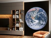 Swirling white clouds are visible over the blue oceans.

