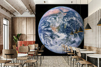 The planet is a sphere, with a clear view of continents and oceans.

