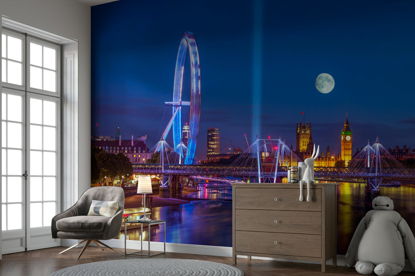 The River Thames is in the foreground, reflecting the city lights.

