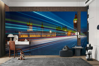 An energetic wall mural with a view of London at night.

