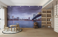 The city skyline is visible in the background with lights starting to glow.

