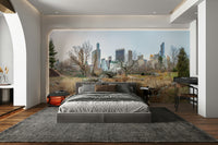 The bridge is made of stone and is arched over a calm body of water.

