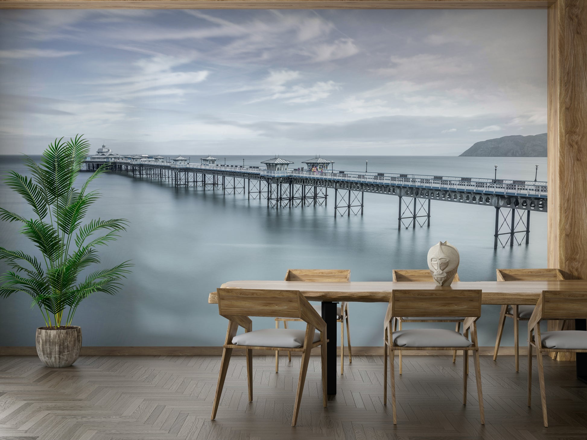 The sea is calm and smooth, reflecting the sky.

