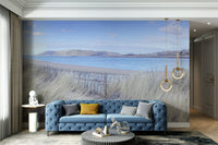 Rolling green hills or cliffs are on the coastline.

