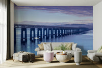 A peaceful wall mural with a panoramic view of a coastline.

