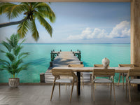 Close-up of a pier extending over calm tropical water

