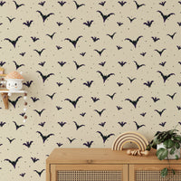 An angled shot of a wall with bat wallpaper

