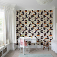 A repeating pattern of cute Halloween cats and pumpkins.
