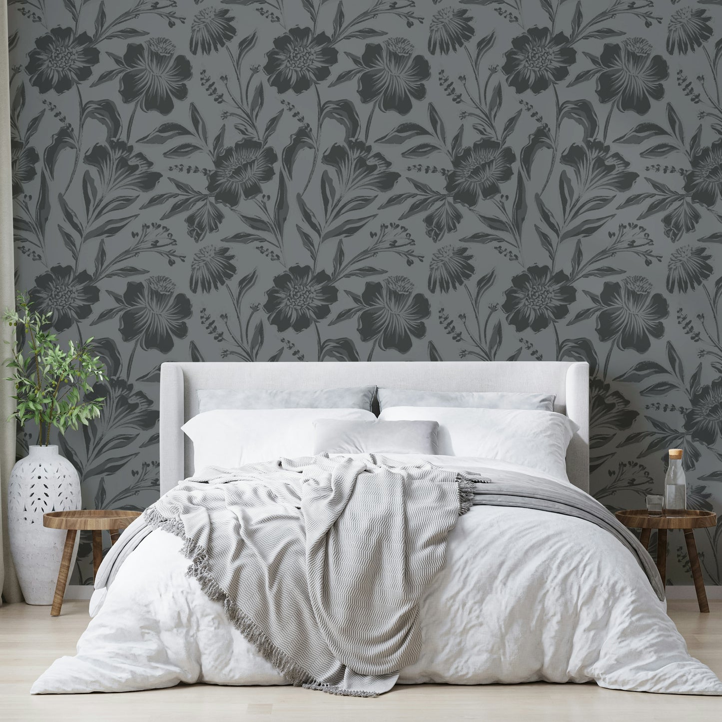 The image features large flowers and leaves depicted as soft silhouettes.
